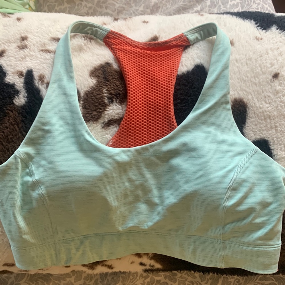 orange and turquoise Outdoor Voices sports bra.